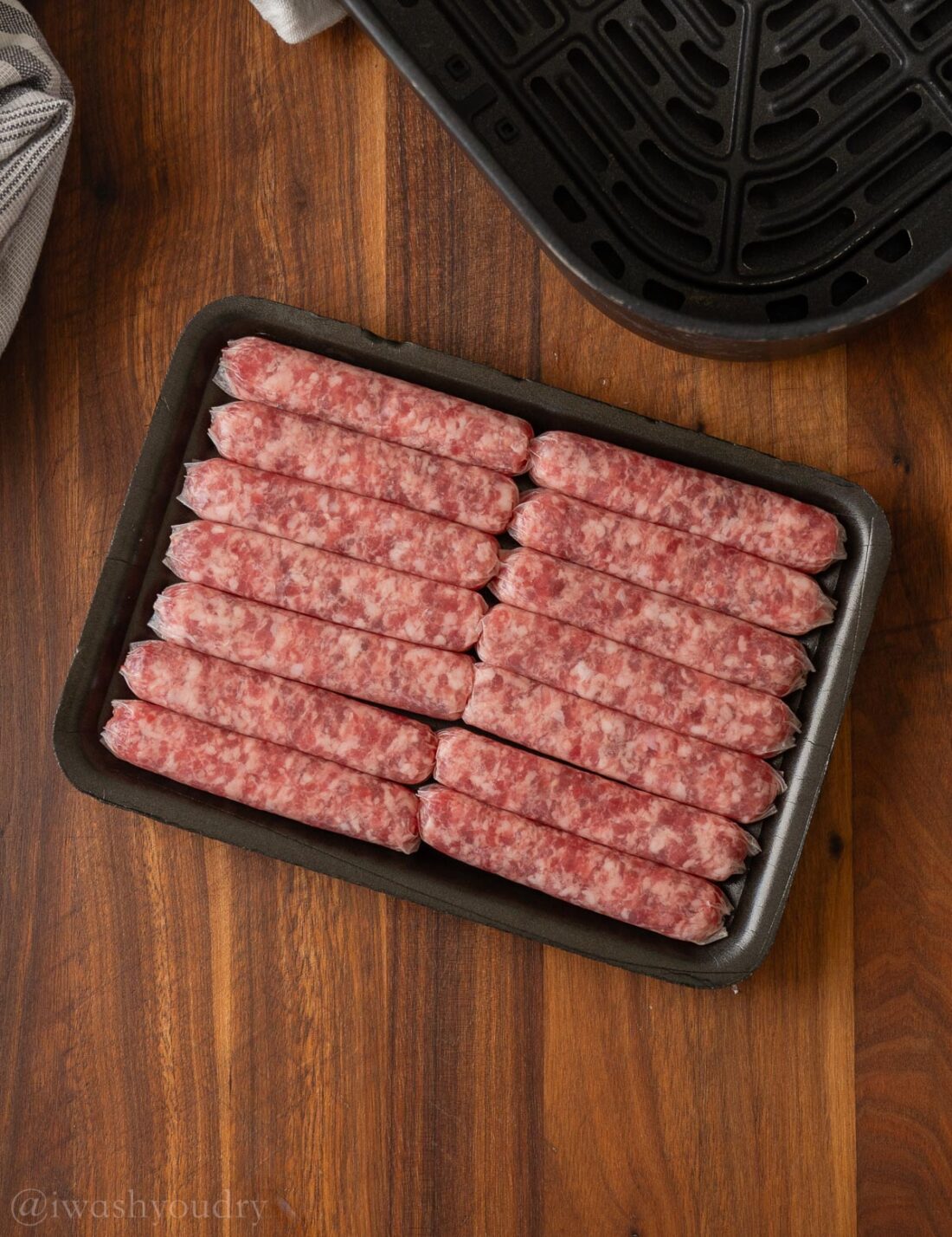 Raw pork sausage in black package. 