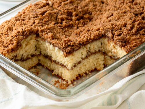 Baked and sliced classic coffee cake in glass pan.