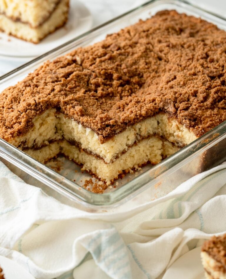 Baked and sliced classic coffee cake in glass pan.