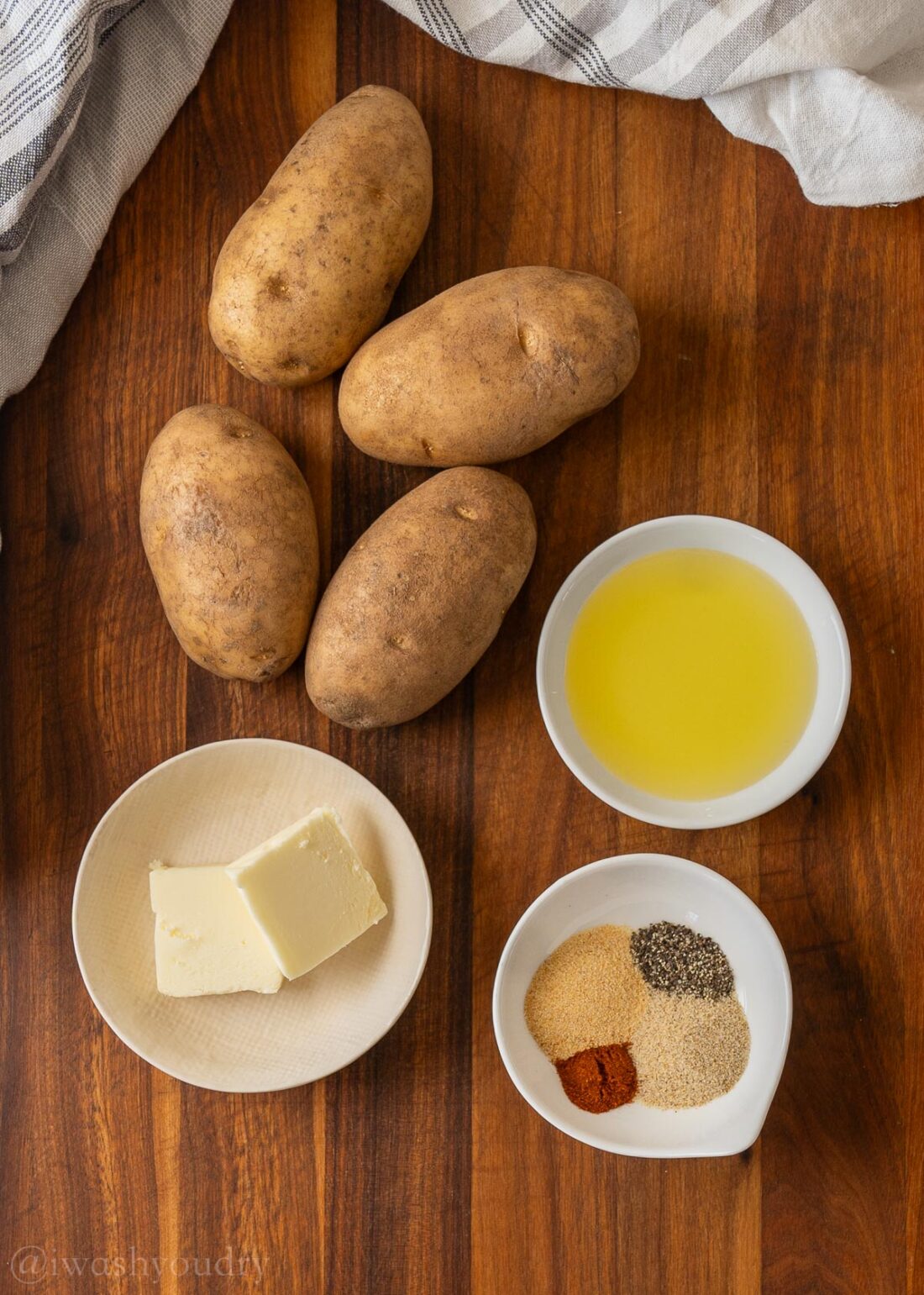 Ingredients for skillet breakfast potatoes on wood cutting board. 