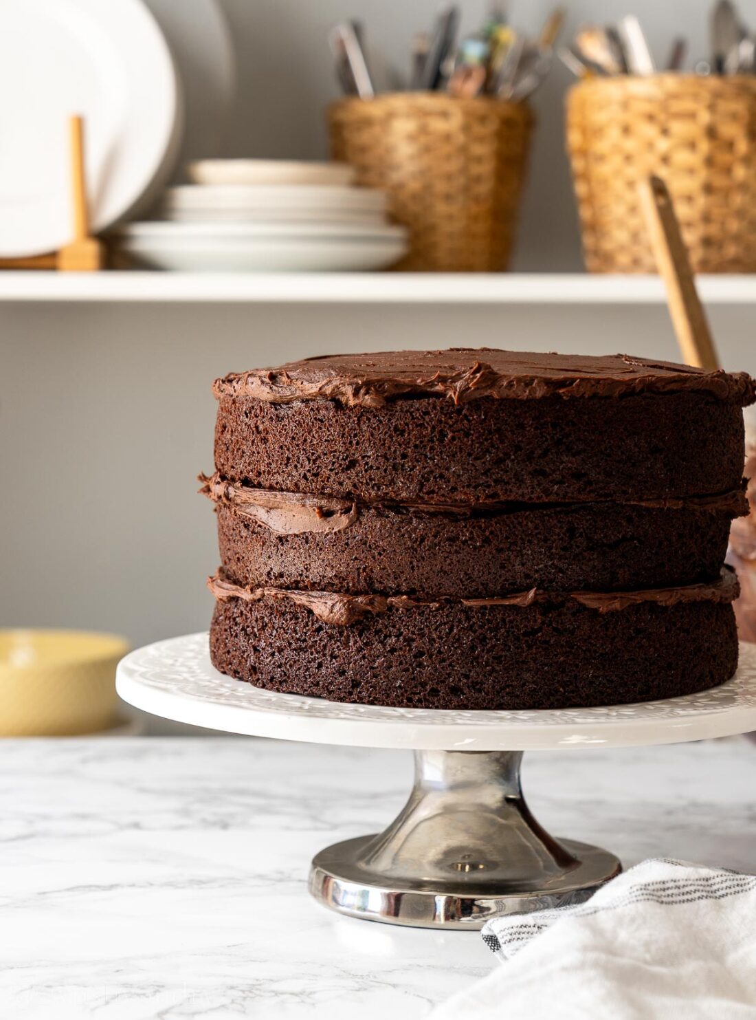 layered chocolate cake rounds with chocolate frosting between each layer.