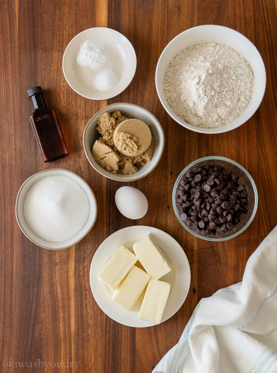 ingredients for chocolate chip cookies on wooden surface.