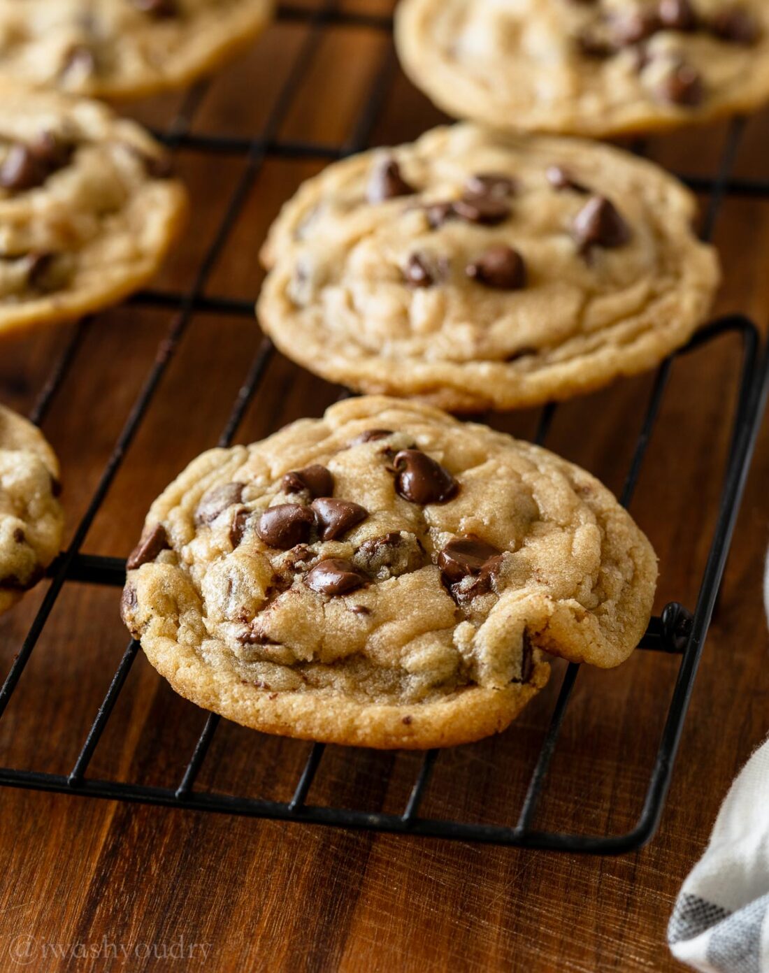 buttery chocolate chip cookies on wire rack.