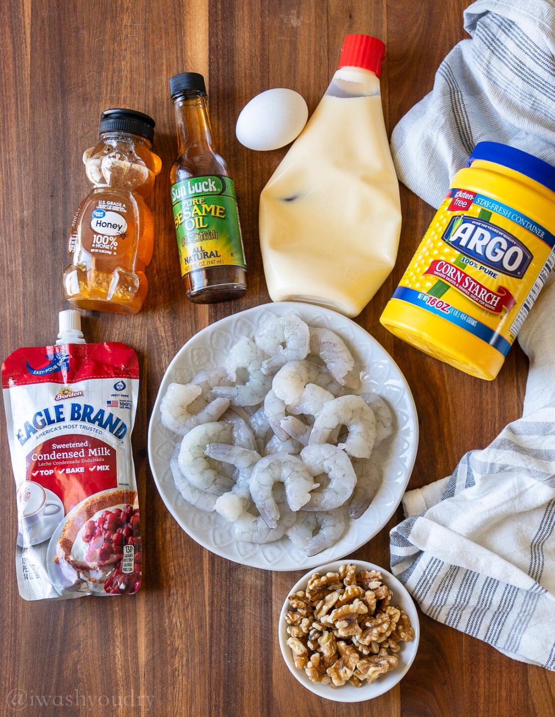 Ingredients for honey walnut shrimp on wooden surface.