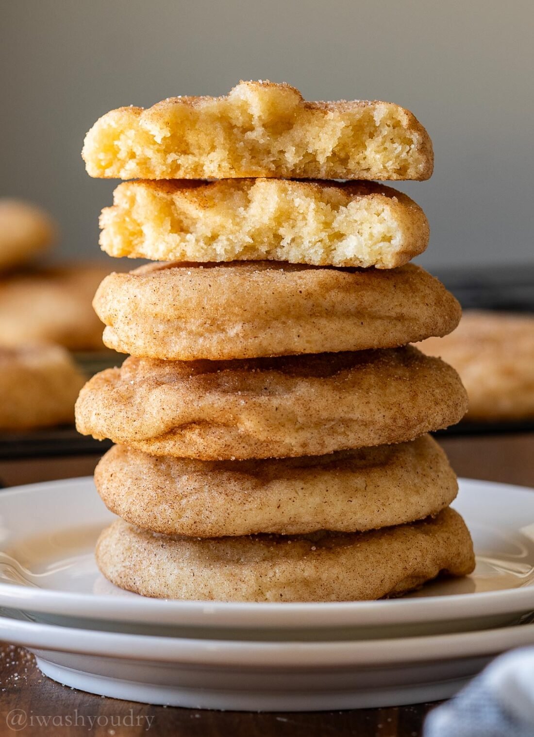 stack of snickerdoodle cookies on white plate.