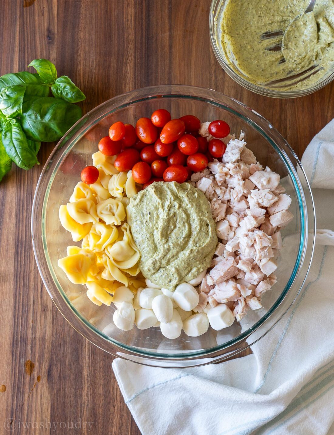 glass bowl with tortellini, tomatoes, mozzarella and sauce.