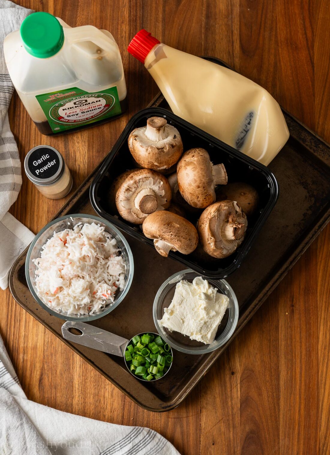 ingredients for stuffed mushrooms on a wooden surface.