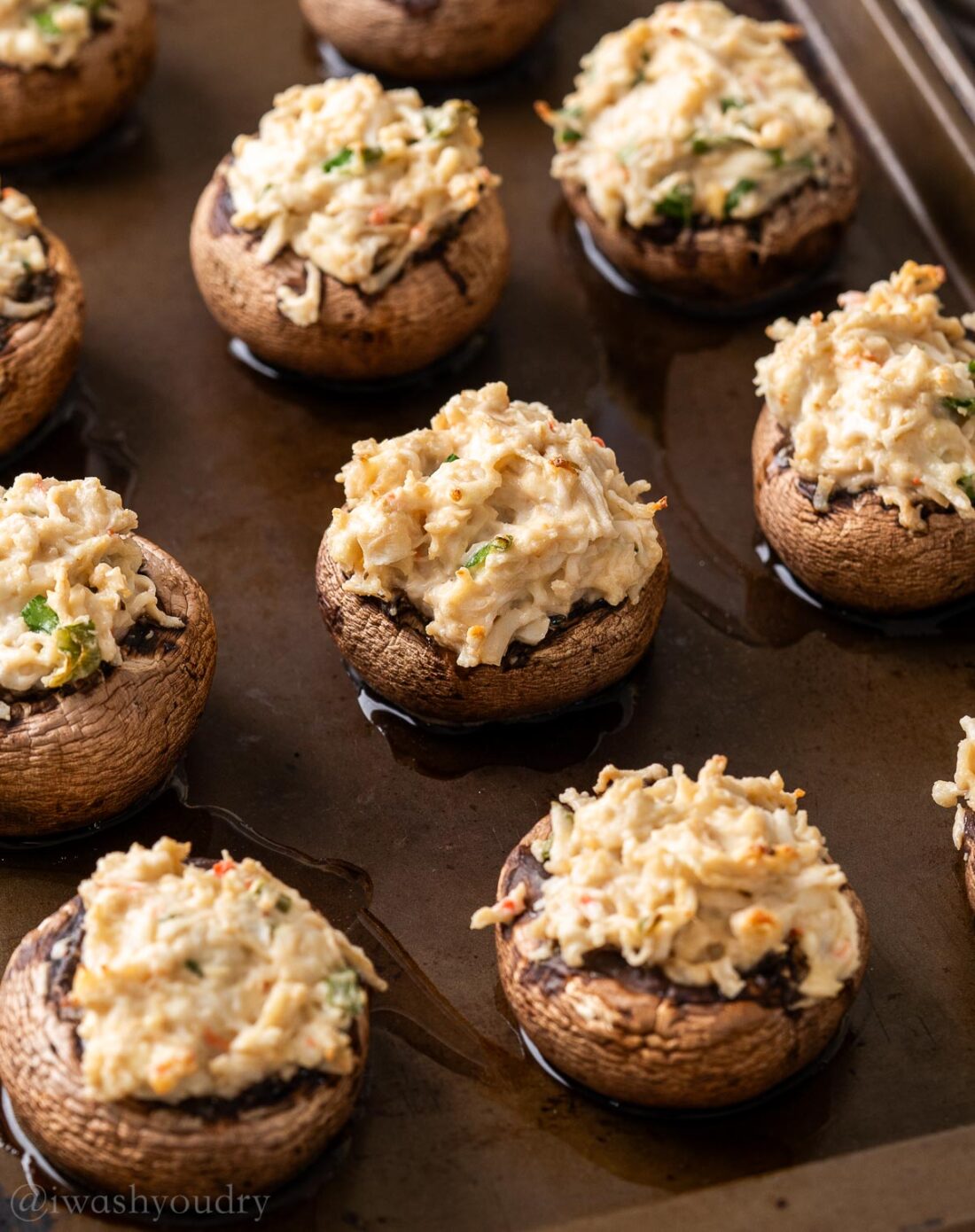 baked mushrooms on a pan with crab filling.