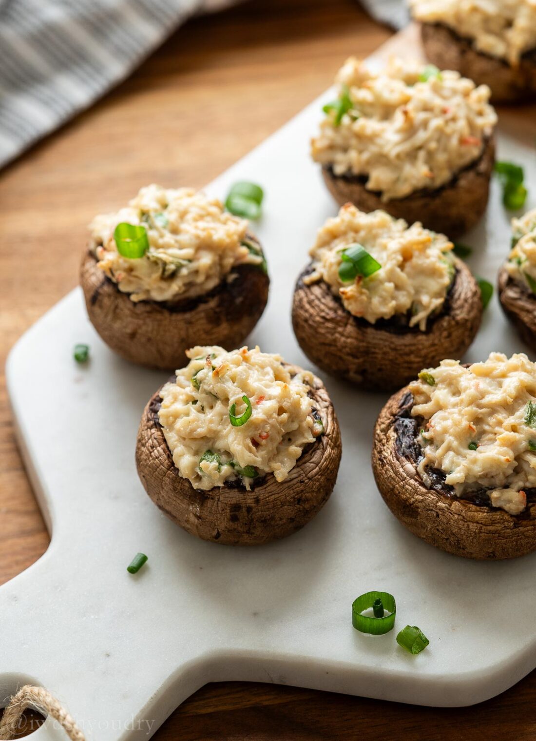 mushrooms stuffed with crab and cream cheese, topped with green onions.