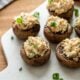 mushrooms stuffed with crab and cream cheese, topped with green onions.