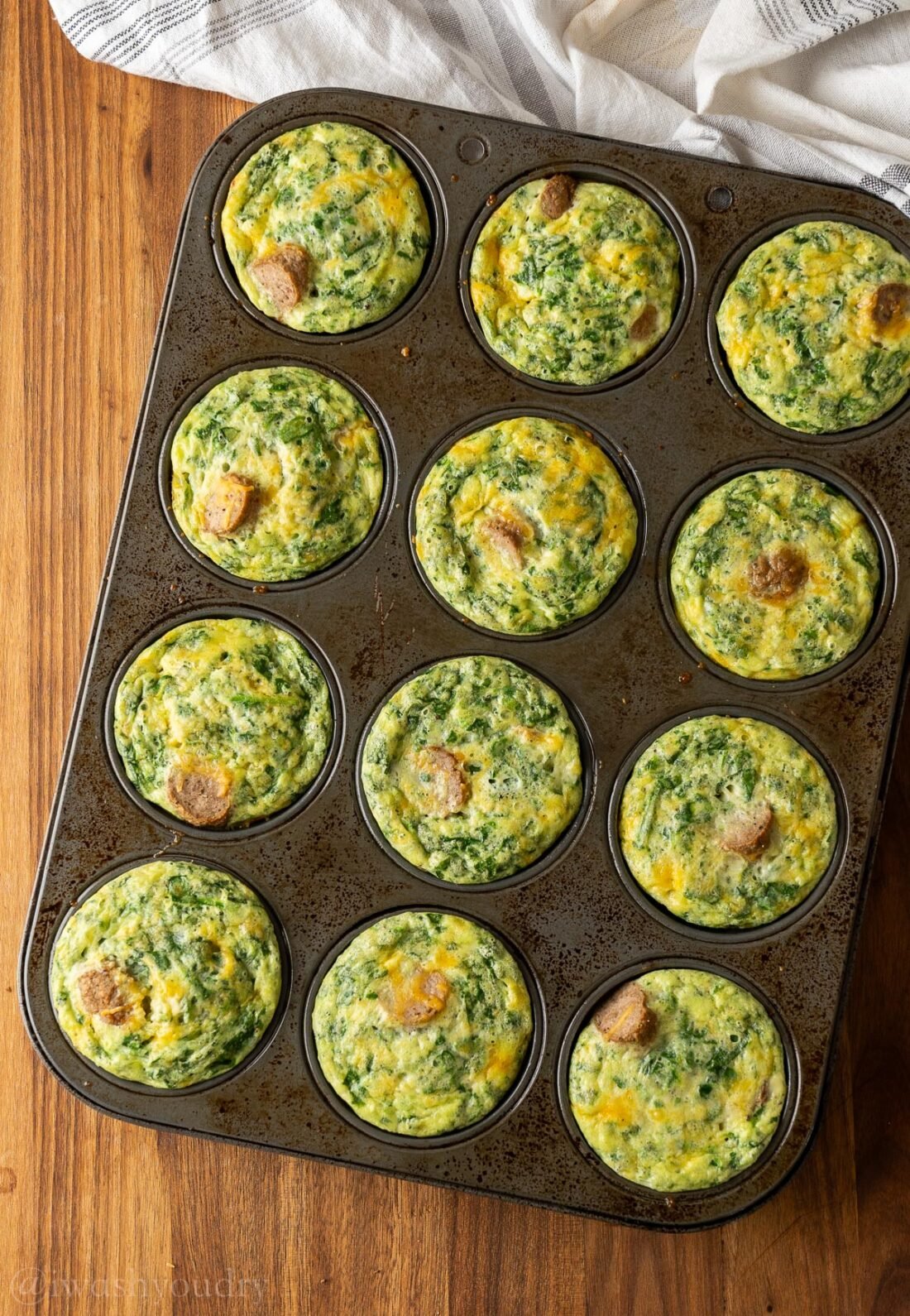 muffin tin with egg bites filled with cottage cheese.