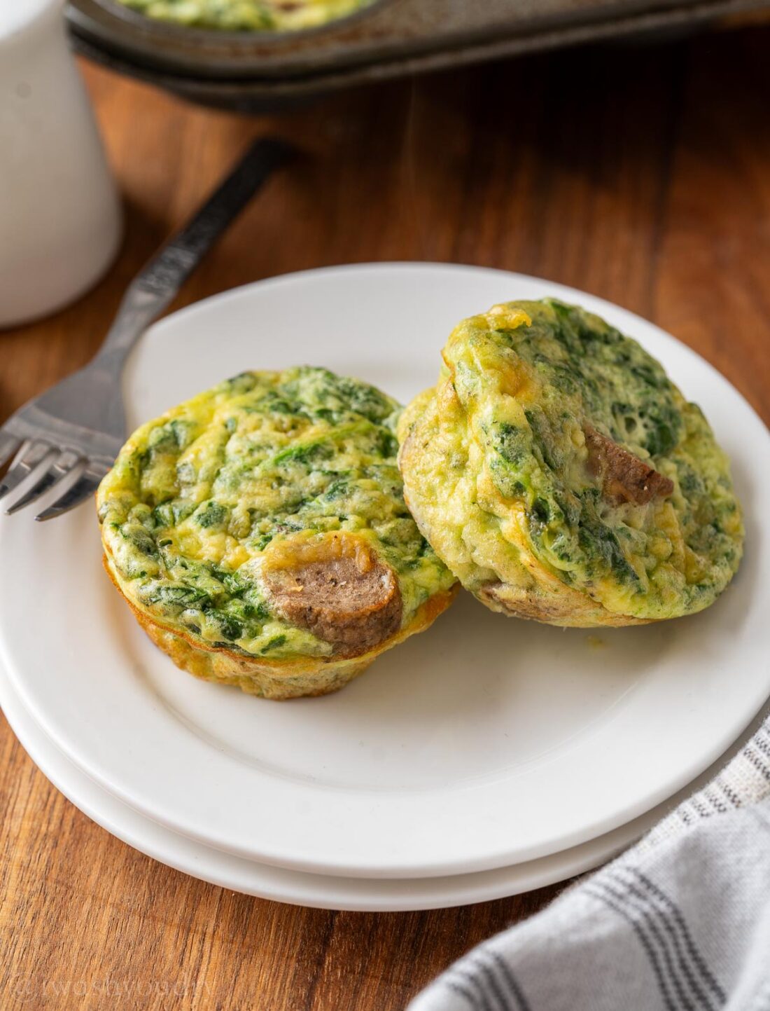 two egg bites on a white plate.