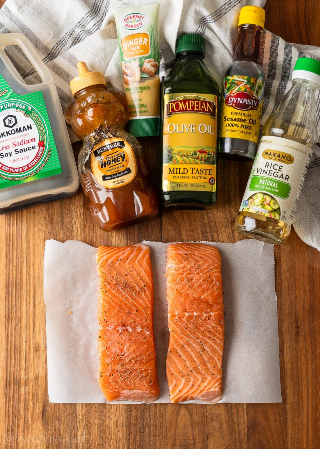 Ingredients for salmon bowls on wooden surface.