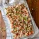 glass casserole dish with raw tuna poke in creamy and spicy mayo sauce.