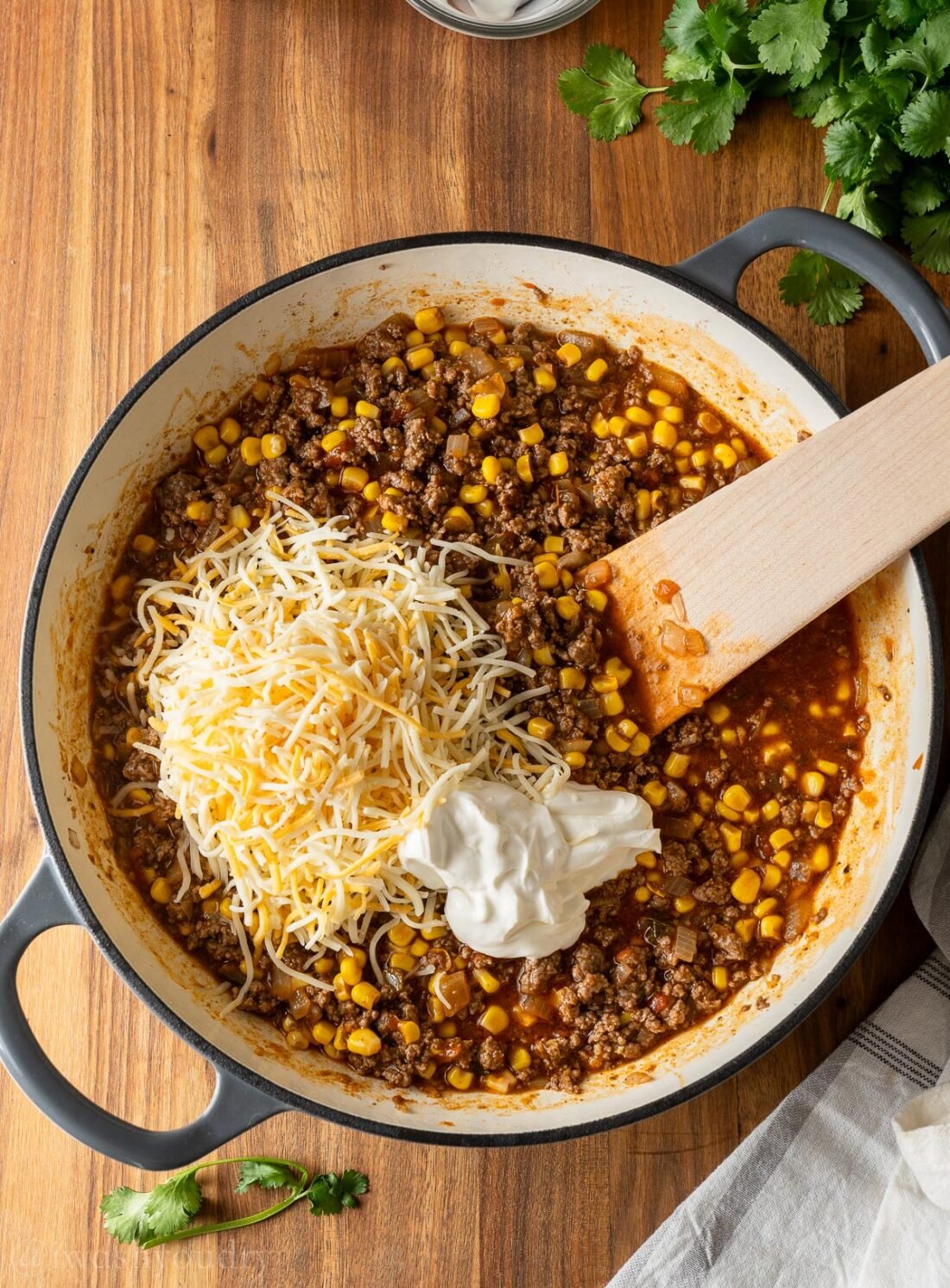 enchilada beef mixture with cheese and sour cream on top.