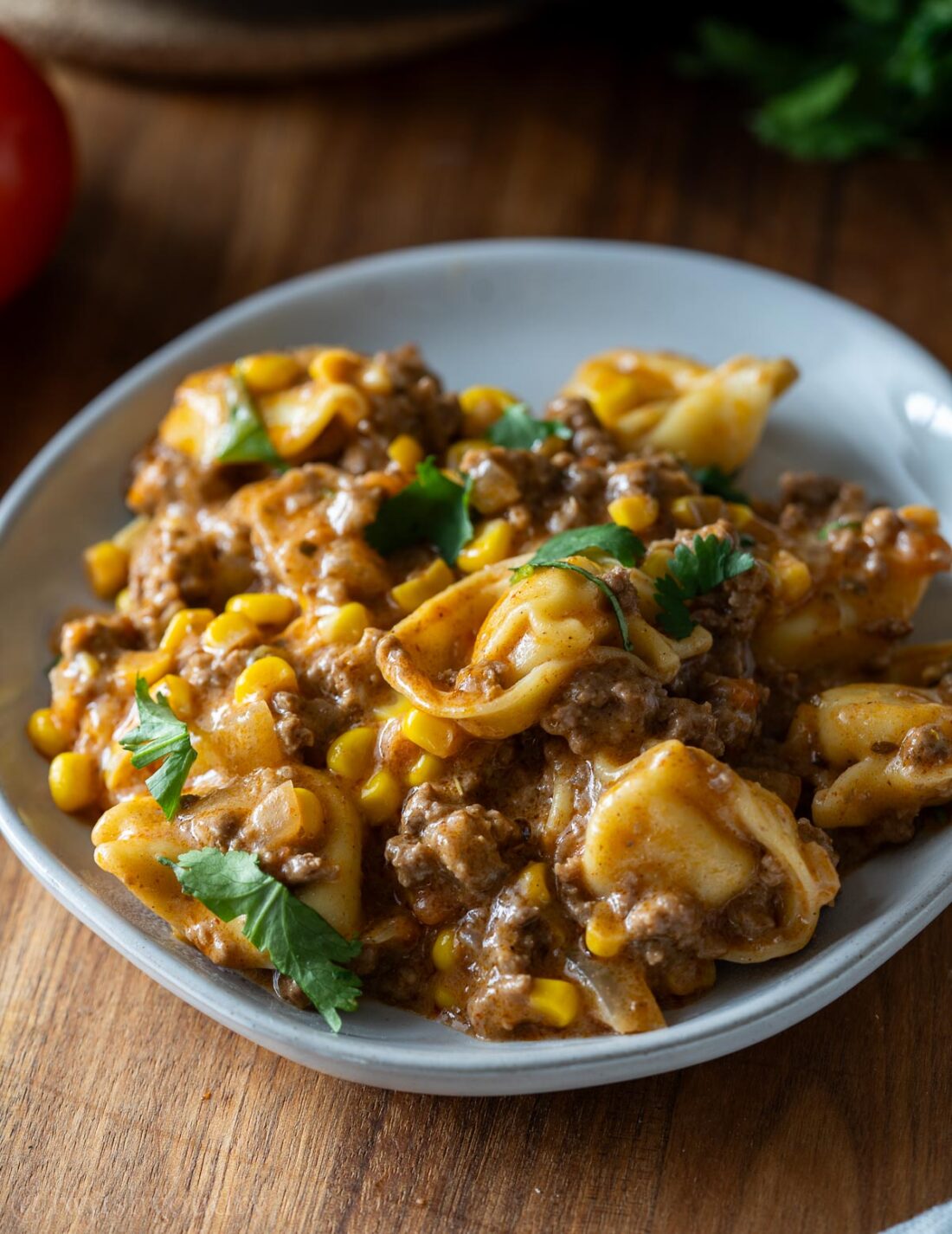 plate filled with cheesy tortellini in a creamy sauce.