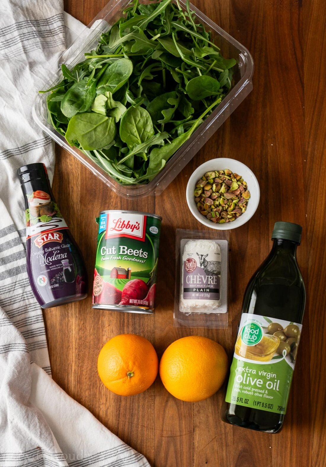 ingredients for beet and goat cheese salad on wooden surface.