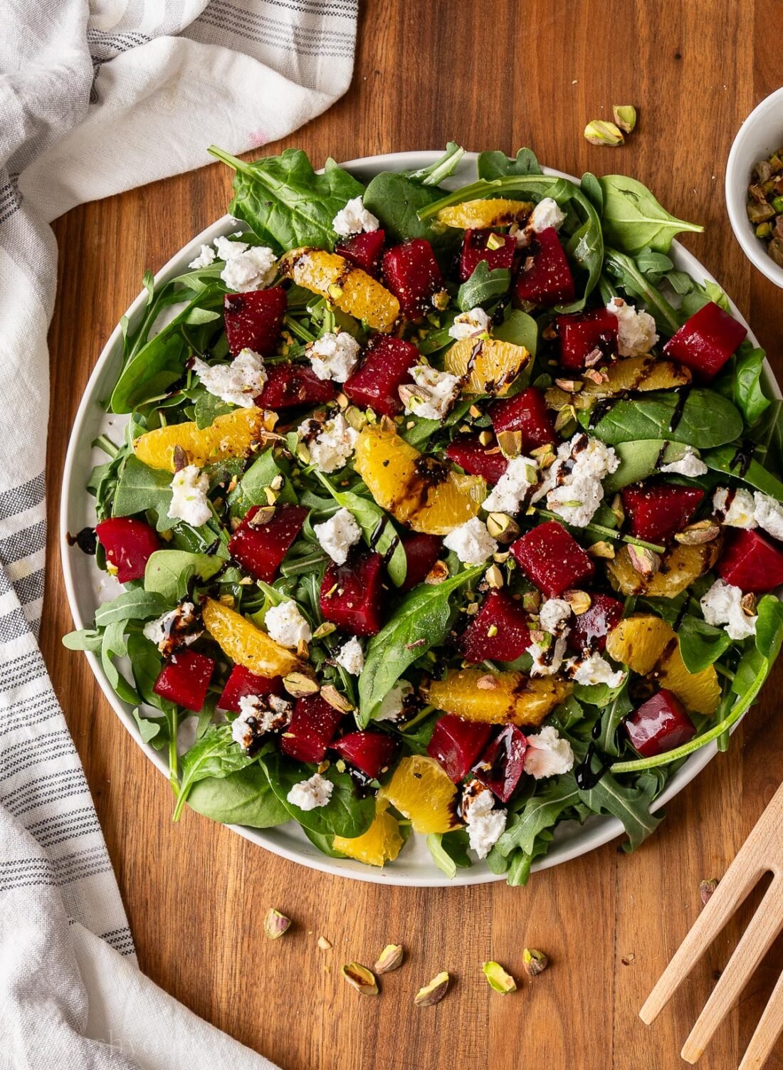 platter with beet and goat cheese salad and a drizzle of balsamic glaze.