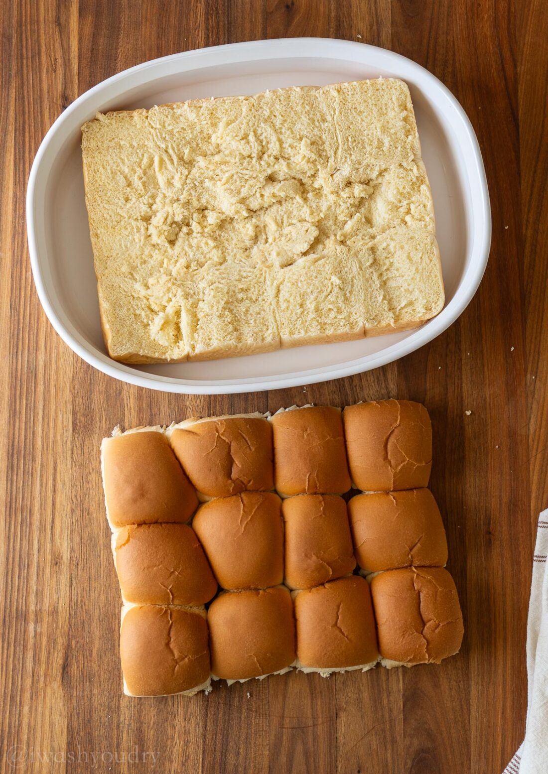 halved dinner rolls in casserole dish.