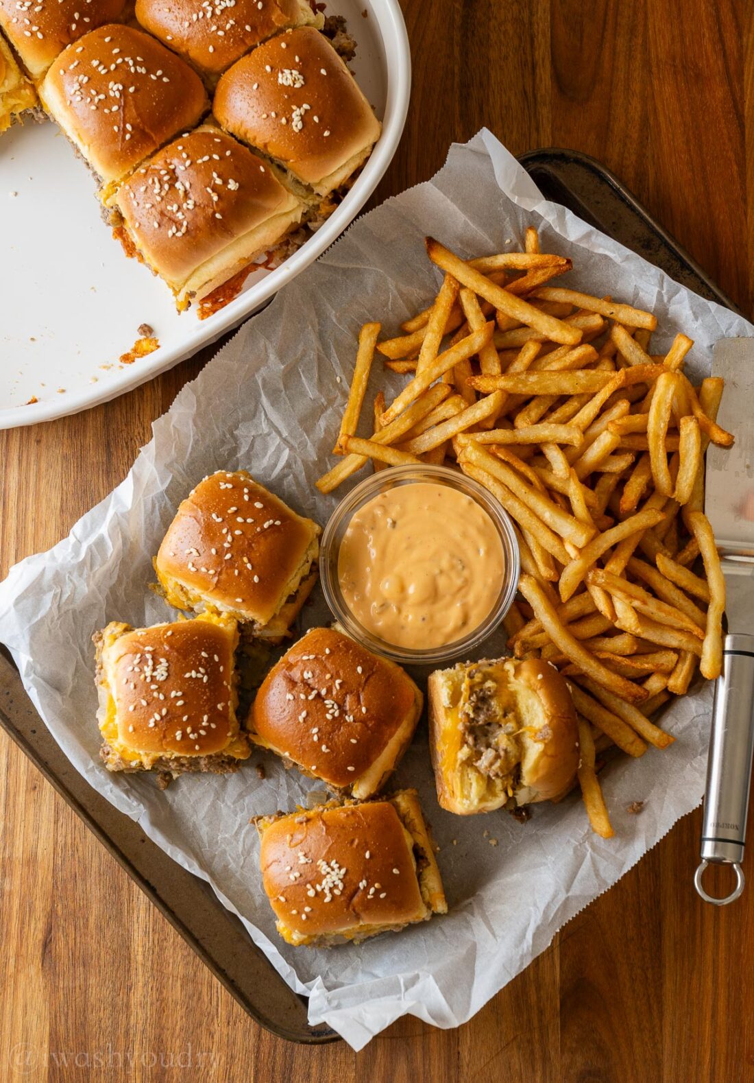 sliders on a baking tray with french fries and big mac sauce on the side.