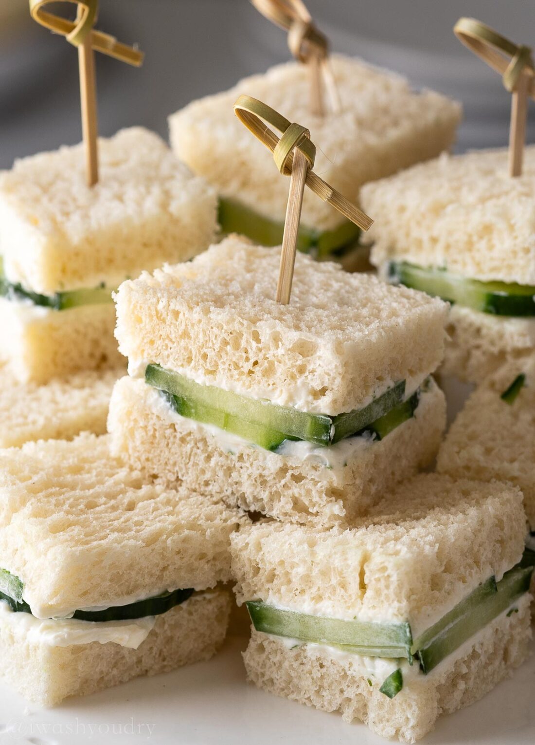 cucumber sandwiches on platter with toothpicks.