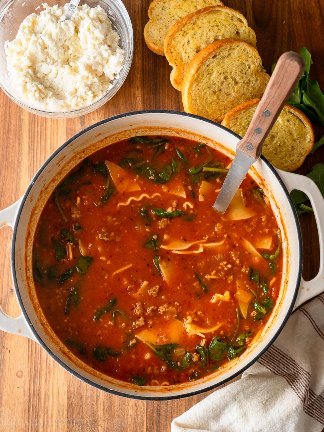 lasagna soup recipe in dutch oven with garlic bread on the side.