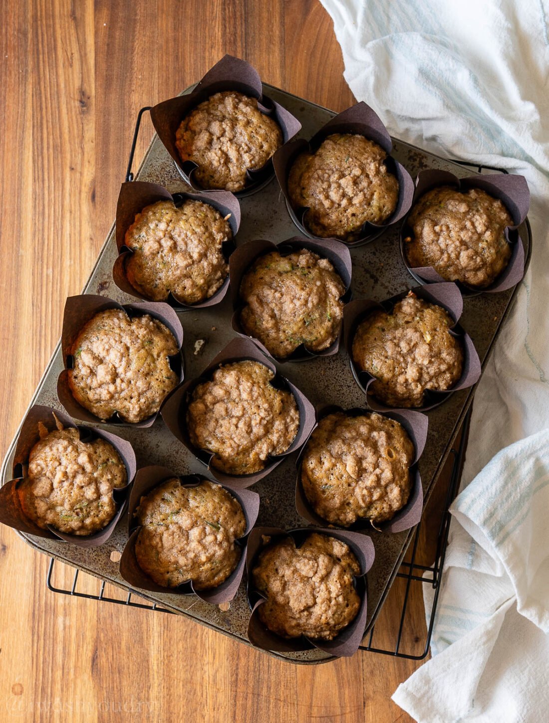 zucchini muffins cooling on a wire rack.