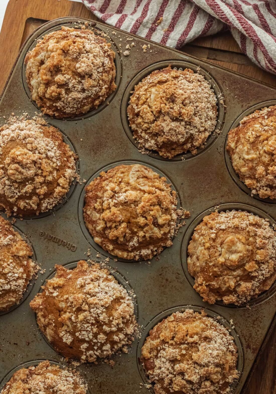 tray of pumpkin muffins with crum topping.