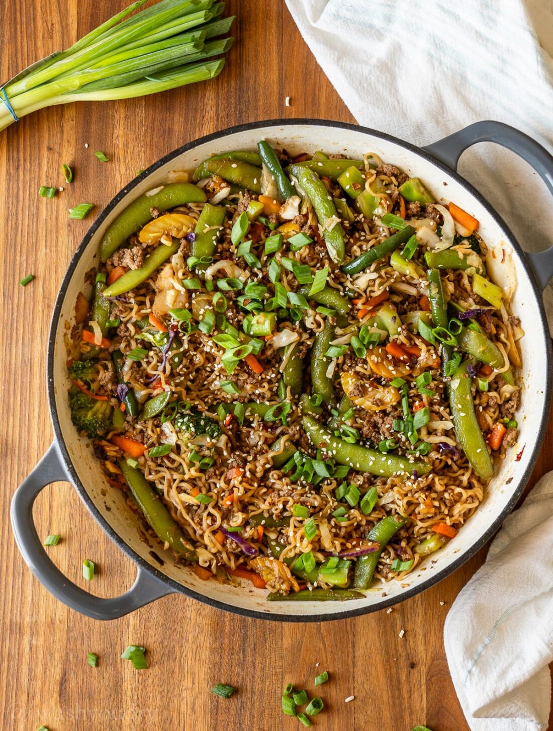 ground beef ramen with stir fry veggies in a cast iron pan.