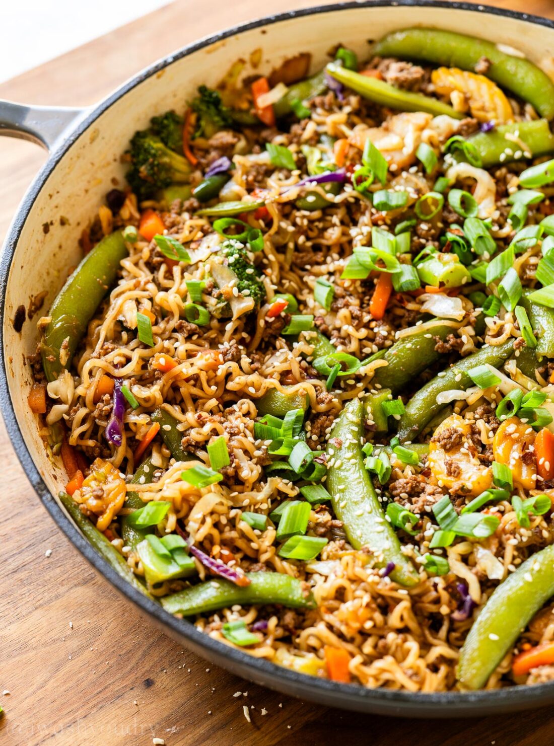 pan filled with ramen noodles, ground beef and stir fry veggies/