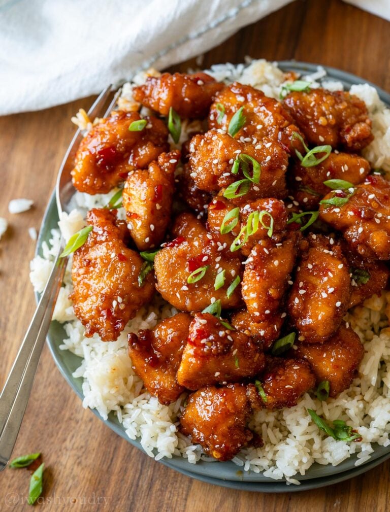 plate with rice and sweet chili chicken on top.