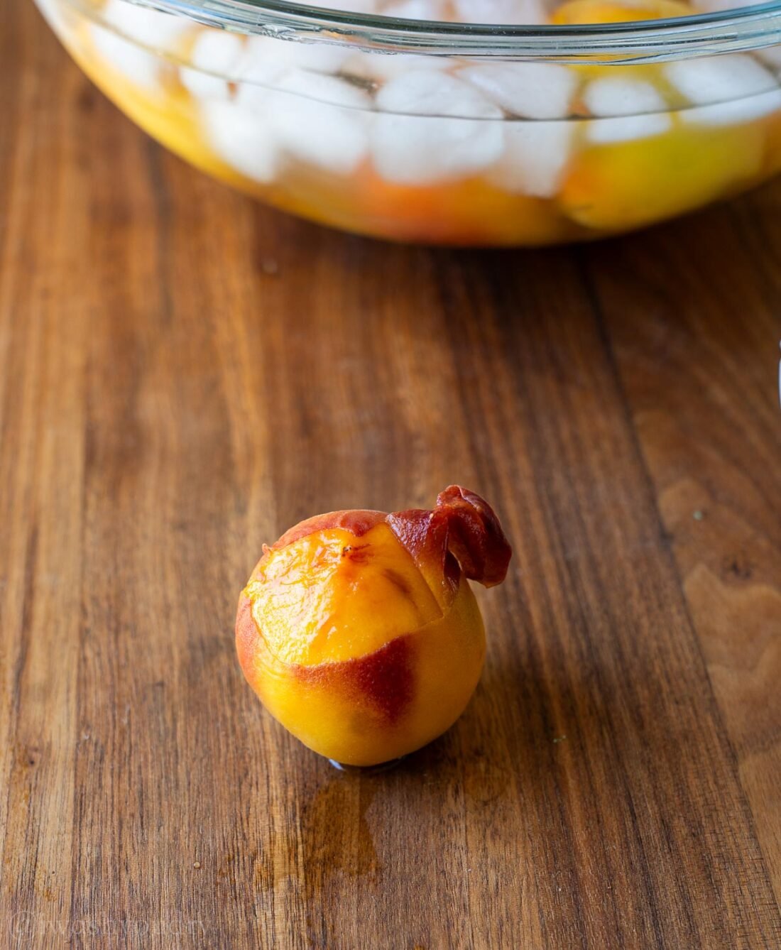 peach skins coming off of fresh peaches.