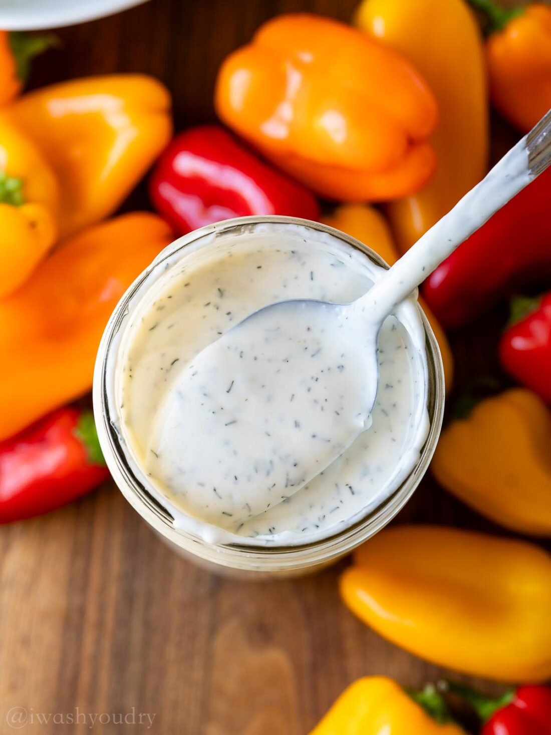 spoon inside mason jar filled with ranch dressing.