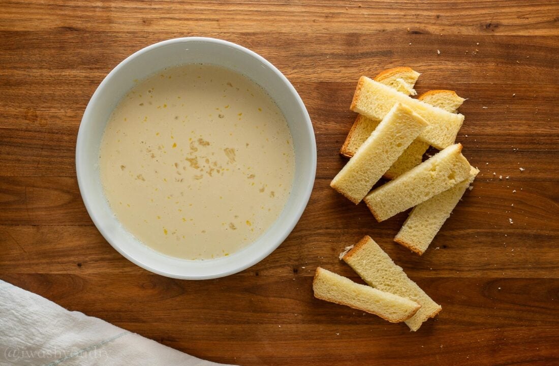 bread cut into sticks next to bowl of egg batter