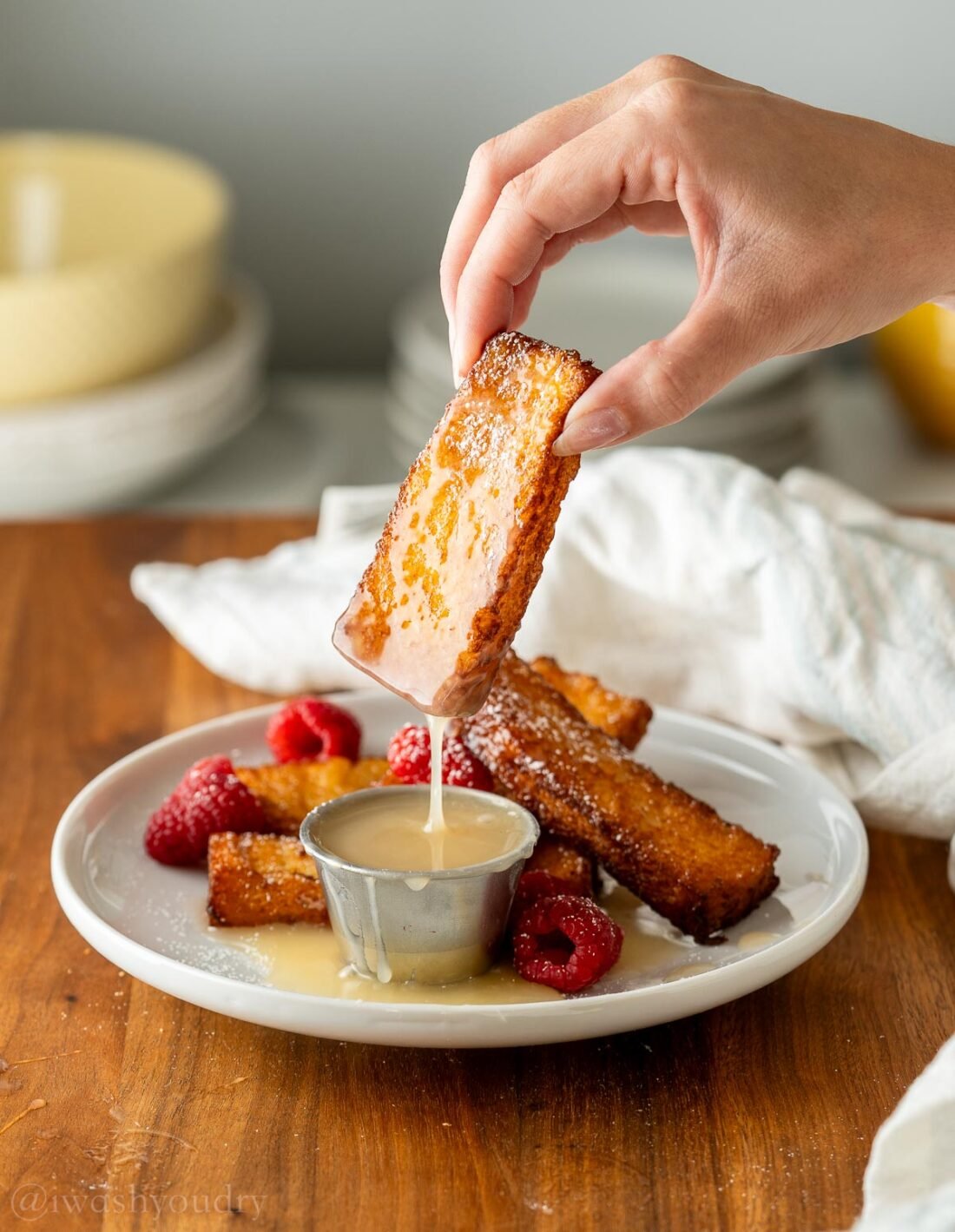 French Toast Sticks-7 French toast stick dunked in buttermilk syrup on white plate