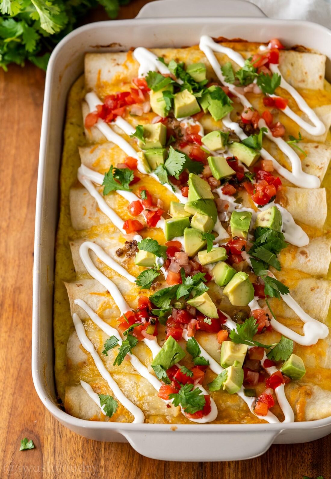 casserole dish filled with loaded breakfast enchiladas.