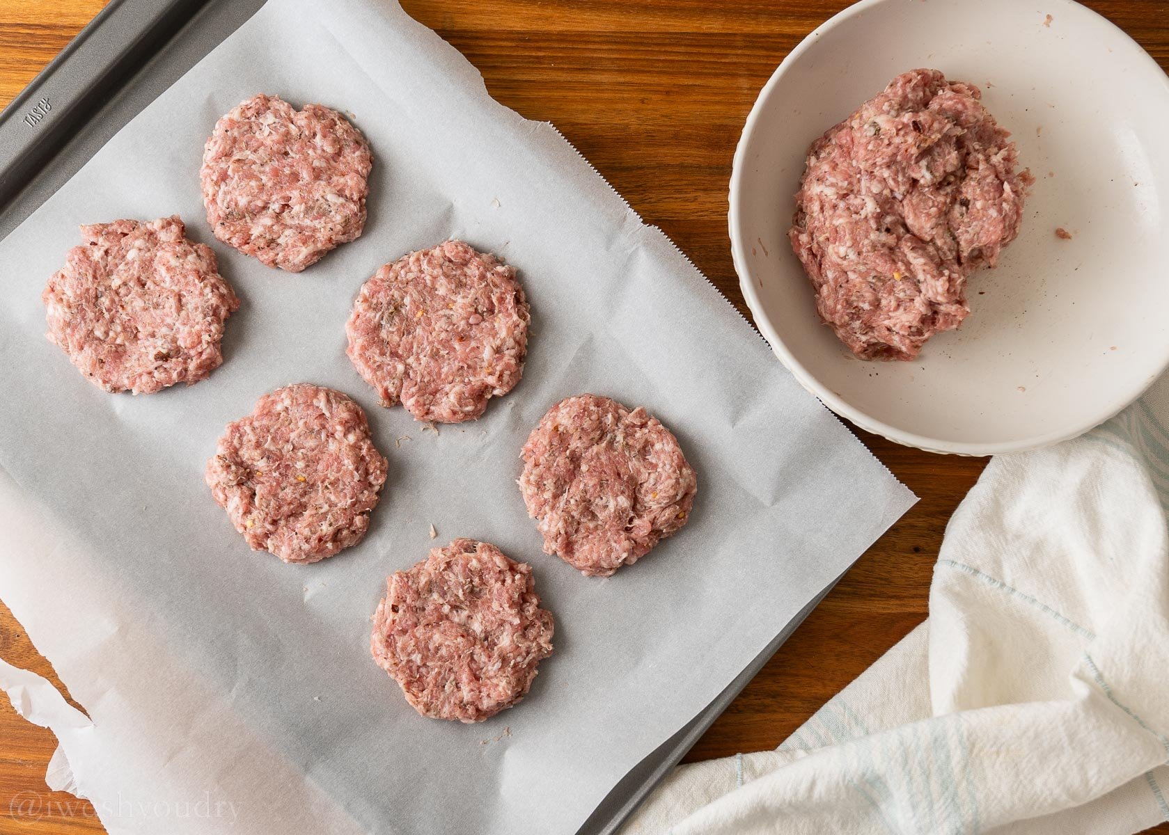 homemade sausage patties on parchment paper.