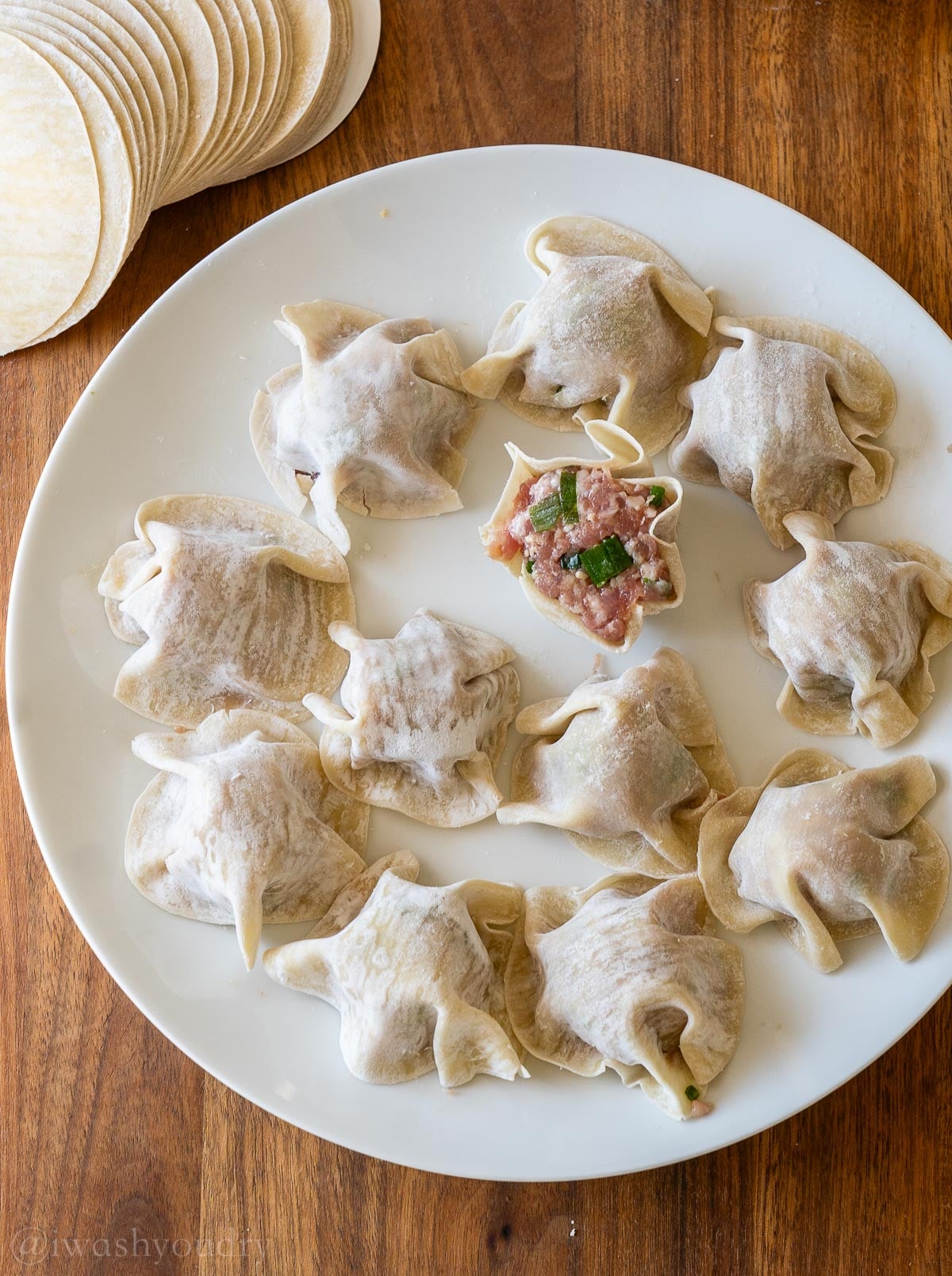 viral pork dumplings on plate uncooked.