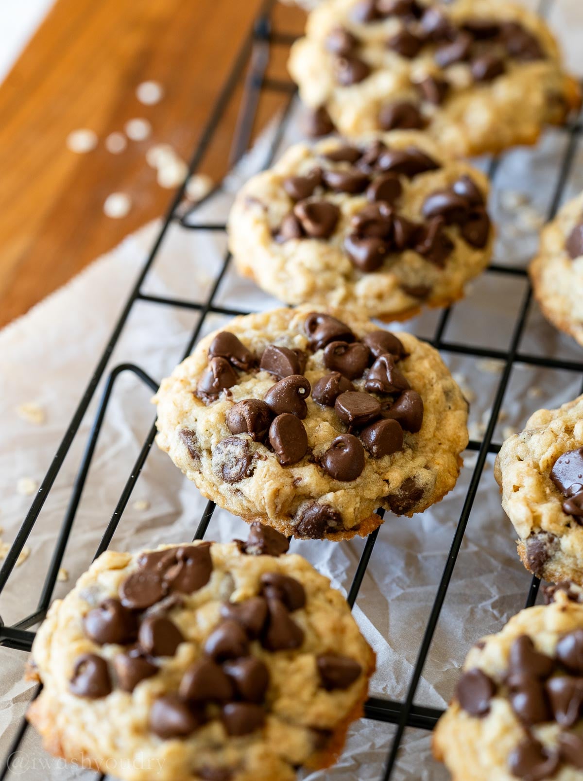 Oatmeal chocolate chip cookies on a cooling rack.