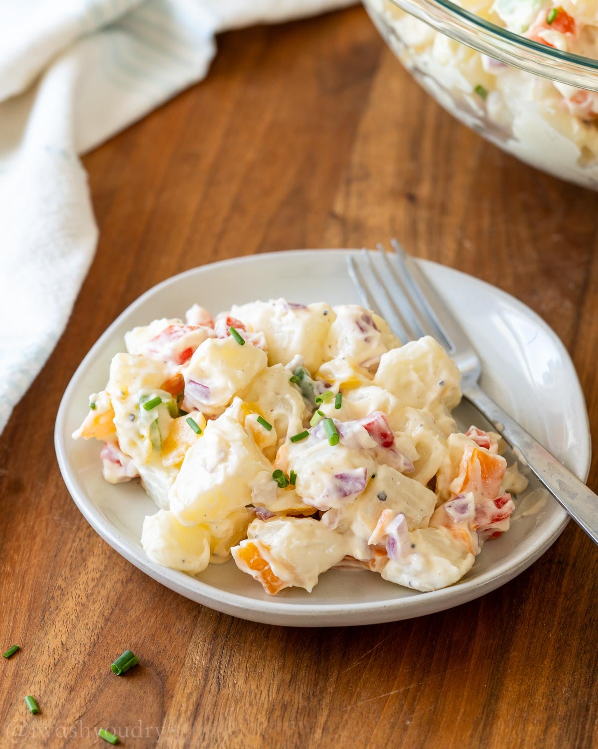 plate of potato salad with fork in it.