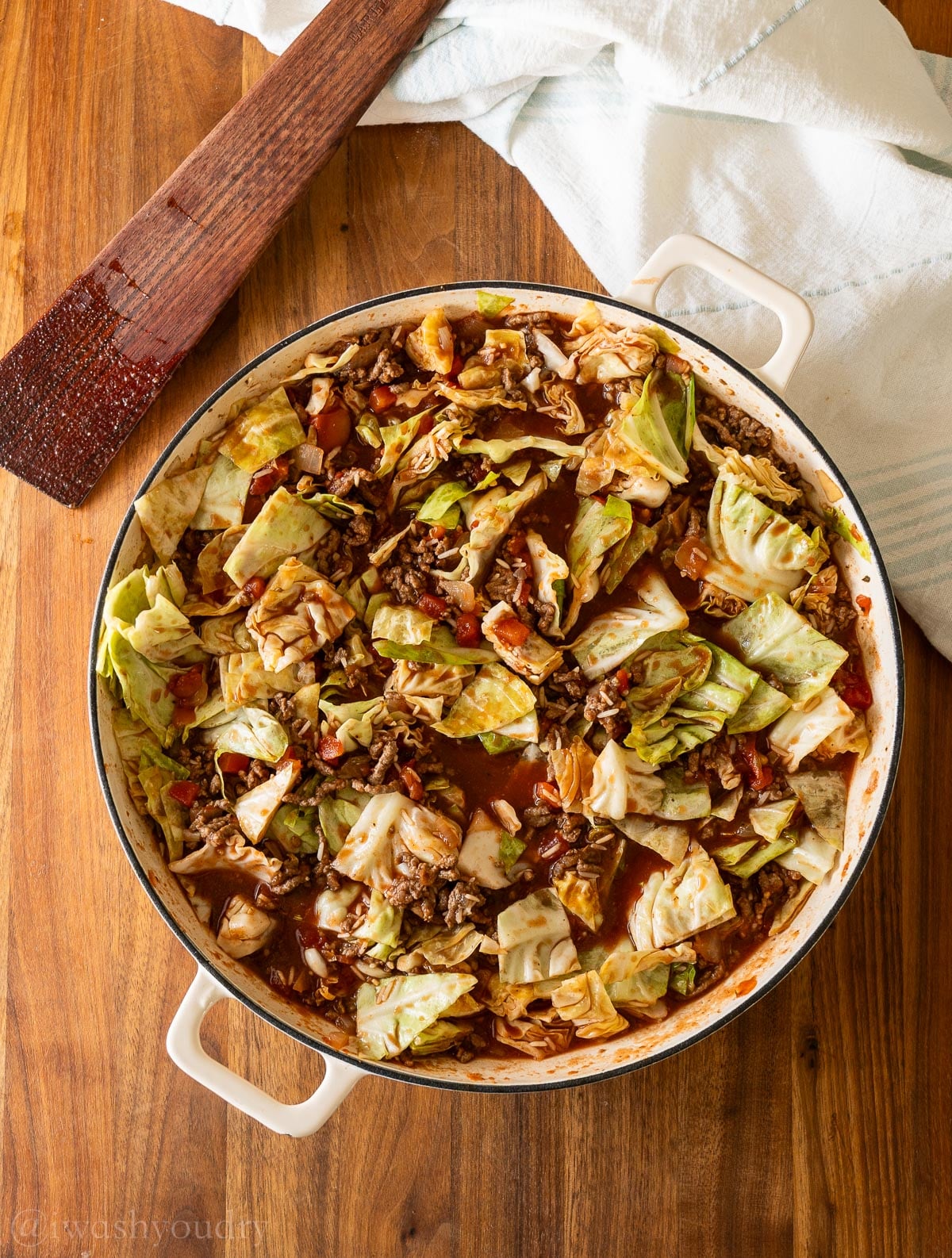 green cabbage in skillet with ground beef mixture.