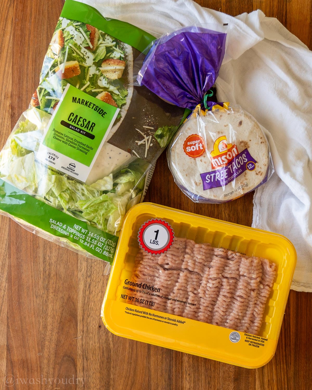 ingredients for chicken Caesar smash tacos recipe on wooden surface.