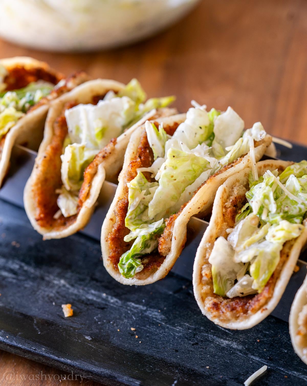 crispy chicken Caesar smash tacos filled with cool and creamy Caesar salad and parmesan cheese.
