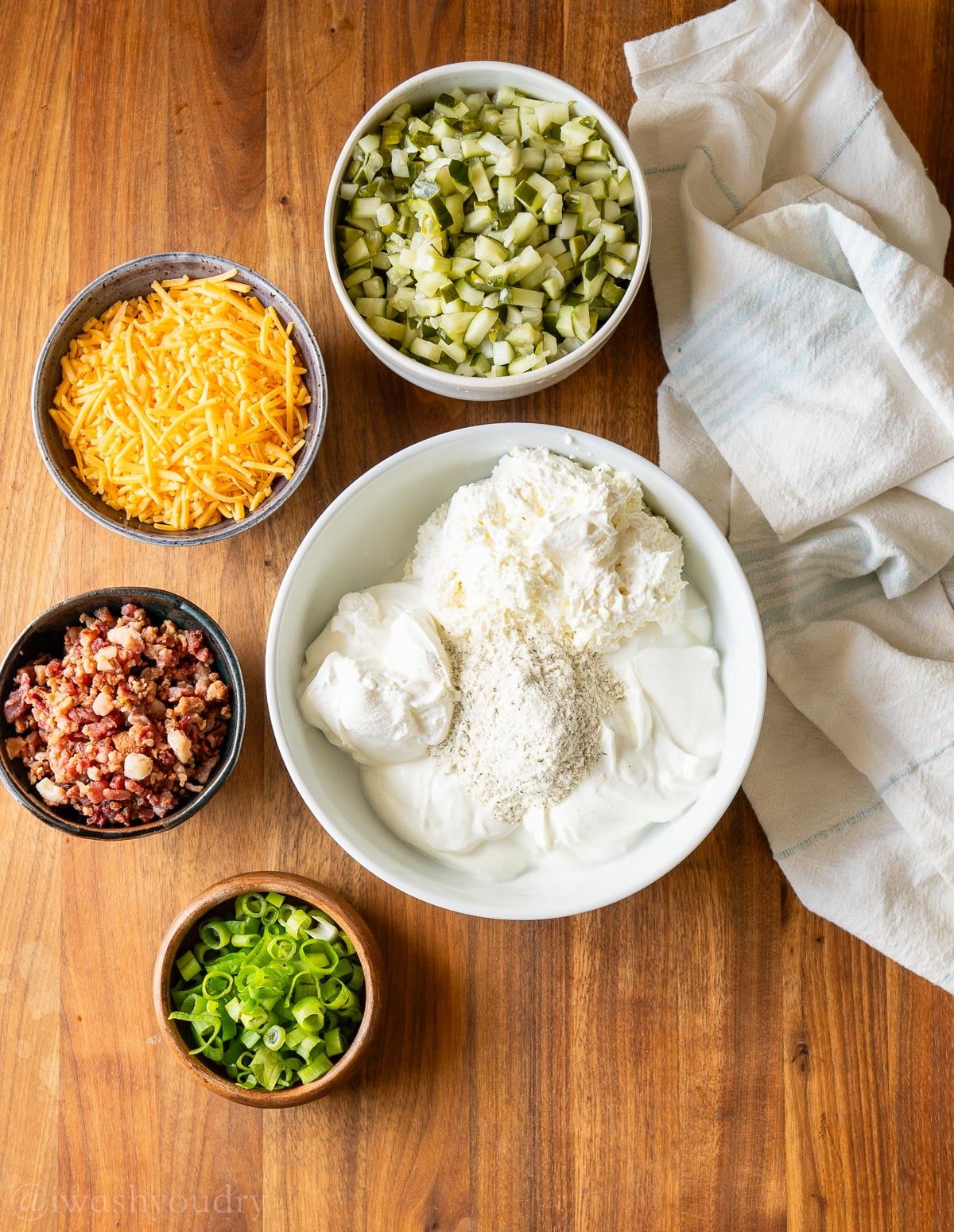 creamy based pickle dip on wooden surface.